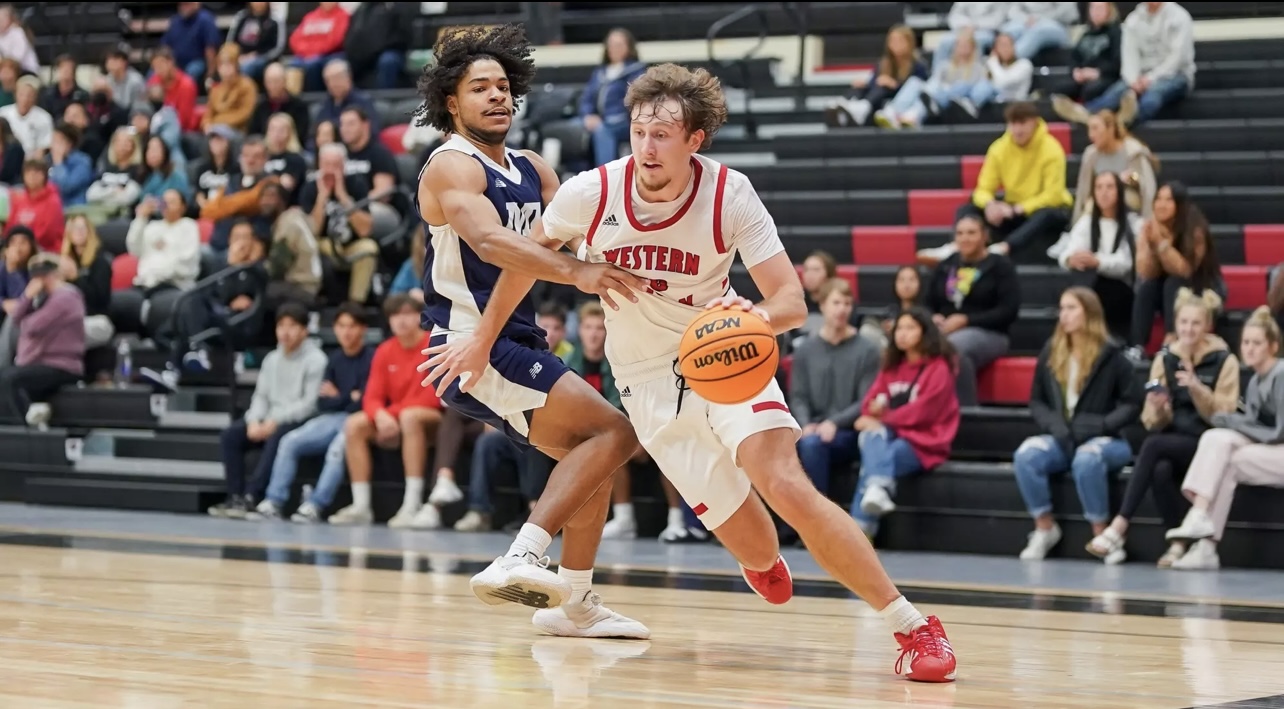 Coach Cam driving to the basket during his Western Oregon college career